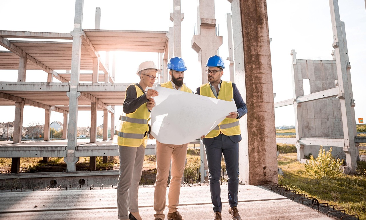 Construction workers in high-vis gear on a large commercial project site